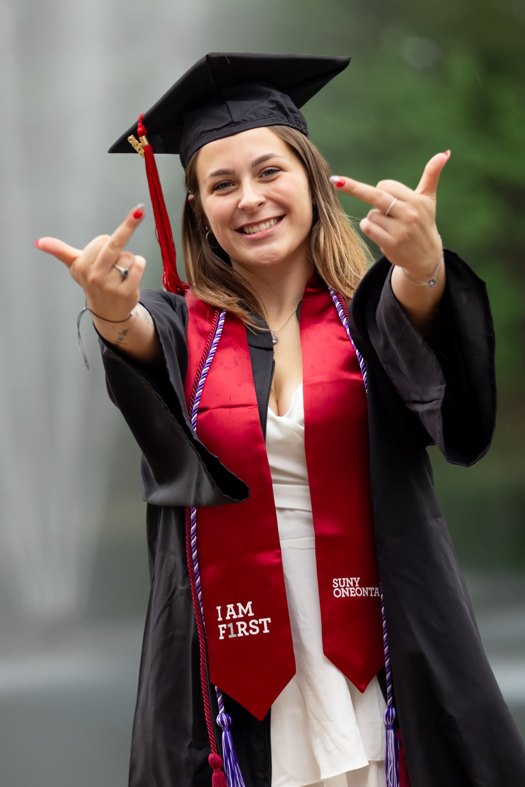 Graduate celebrating with a rock-on gesture